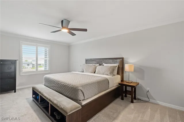 a bedroom with a bed and a ceiling fan