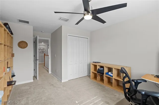 a view of a livingroom with furniture and hallway