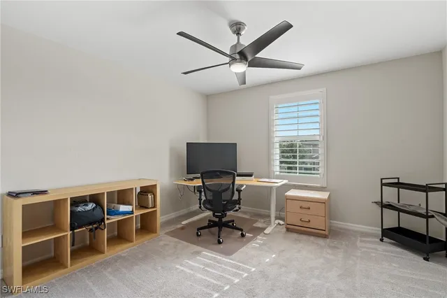 a view of a livingroom with workspace and a window