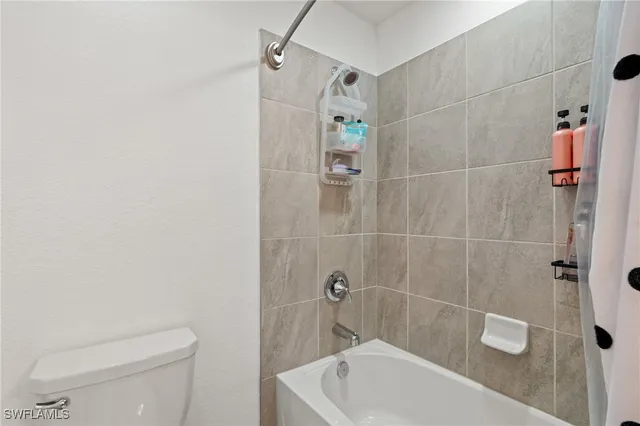 a bathroom with a toilet and shower