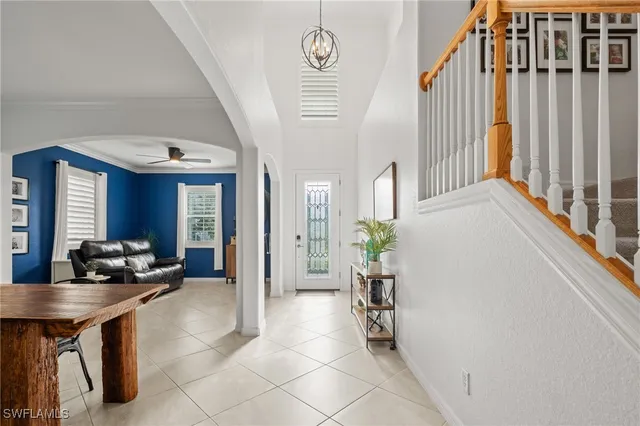 a very nice looking room with a large window and potted plants