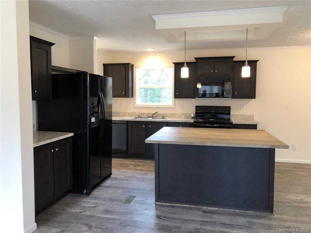 296 Souther Road Fletcher, NC 28732 - Photo 14 of 25 a kitchen with a refrigerator and a sink