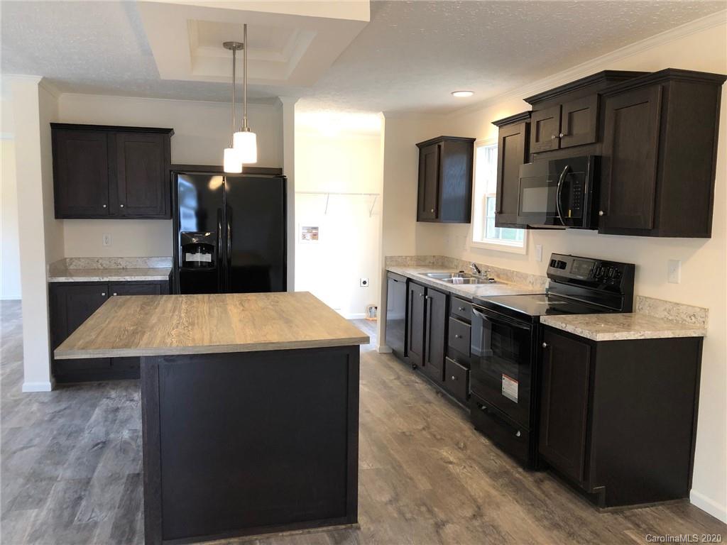 296 Souther Road Fletcher, NC 28732 - Photo 15 of 25 a kitchen with kitchen island granite countertop a sink counter top space and stainless steel appliances