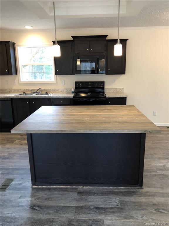 296 Souther Road Fletcher, NC 28732 - Photo 17 of 25 a kitchen with kitchen island sink and stove