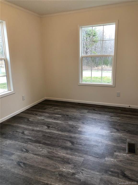 296 Souther Road Fletcher, NC 28732 - Photo 22 of 25 an empty room with wooden floor and windows