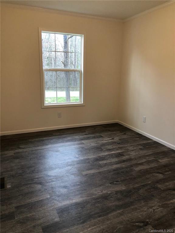 296 Souther Road Fletcher, NC 28732 - Photo 23 of 25 an empty room with wooden floor and windows