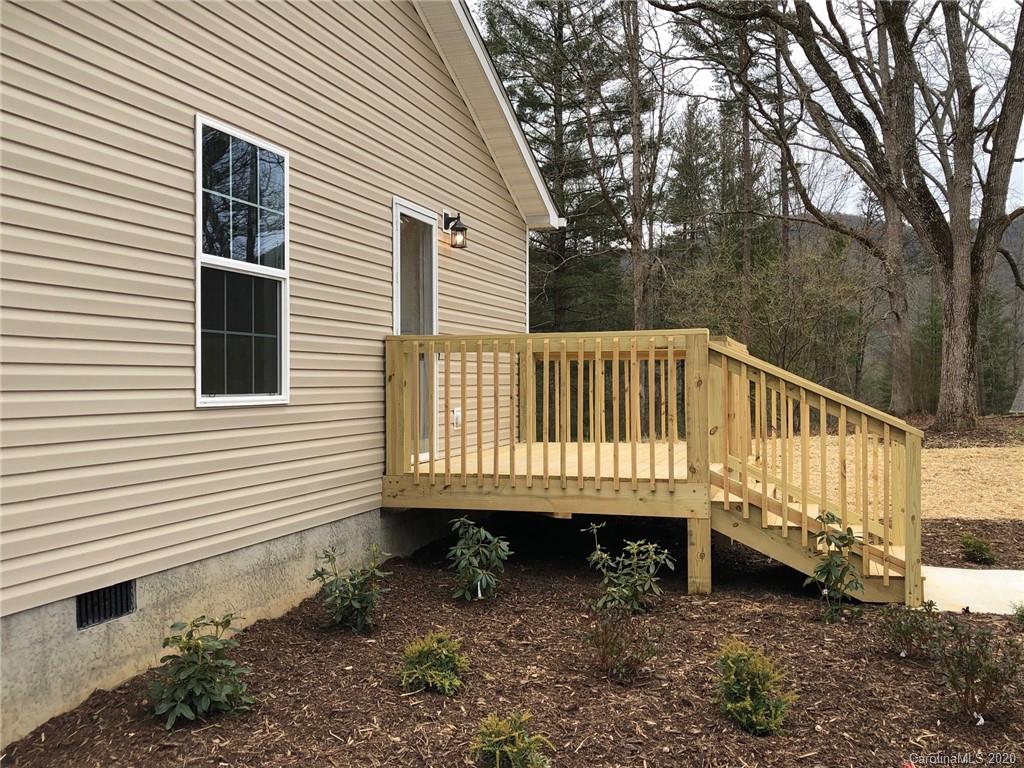 296 Souther Road Fletcher, NC 28732 - Photo 4 of 25 a view of a small house with a yard and wooden fence