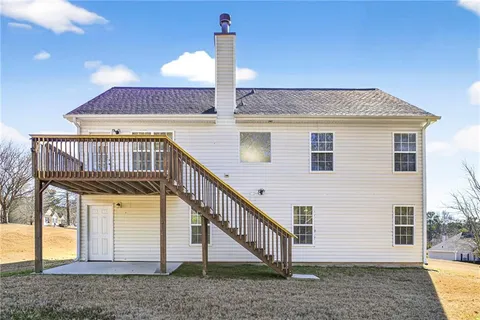 a view of a yard with plants and trees