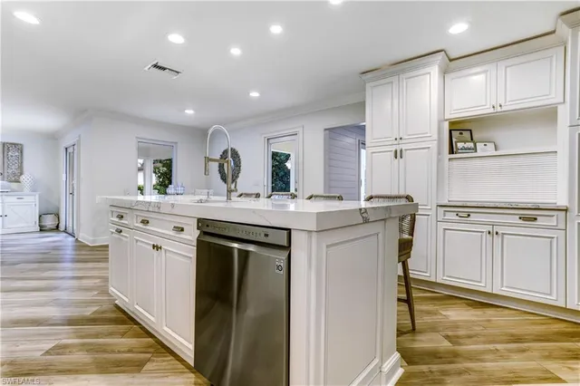 a kitchen with stainless steel appliances kitchen island granite countertop a refrigerator and a stove top oven