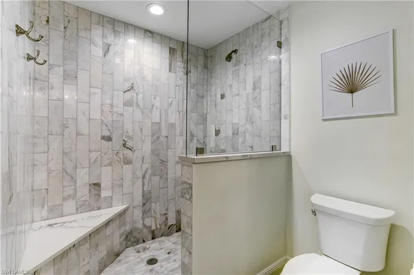 a bathroom with a toilet and a shower