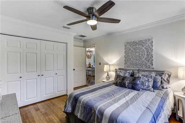 a spacious bedroom with a bed and a ceiling fan