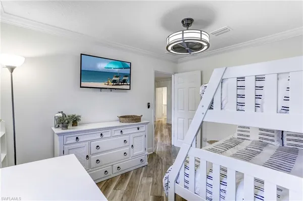 a bedroom with a bed and a chandelier