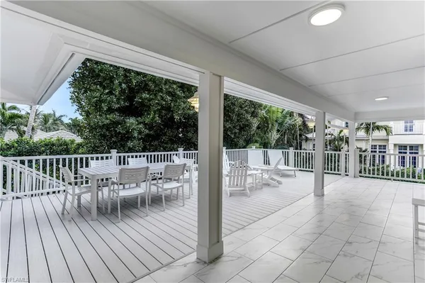 a view of a chairs and table on the wooden deck
