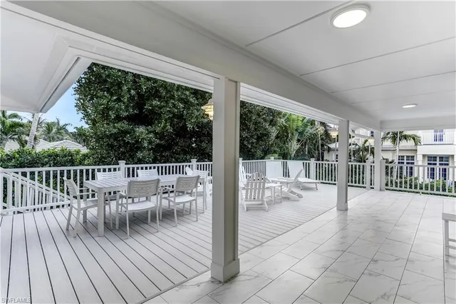 a view of a chairs and table on the wooden deck