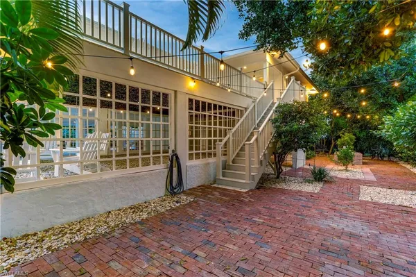 a balcony with table and chairs