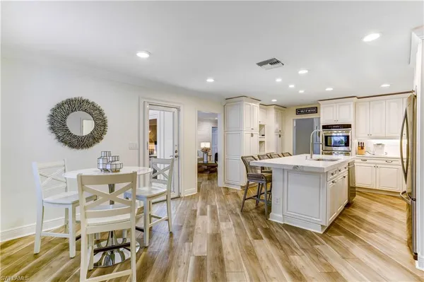 a large kitchen with a table and chairs in it