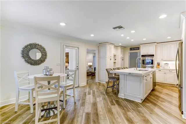 a large kitchen with a table and chairs in it