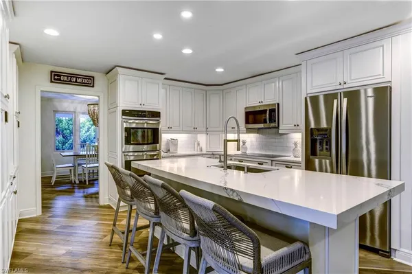 a kitchen with a stove a refrigerator and a dining table