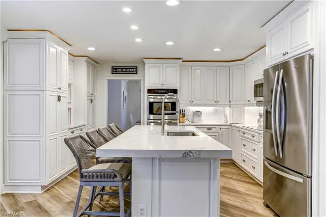 a kitchen with refrigerator cabinets and wooden floor