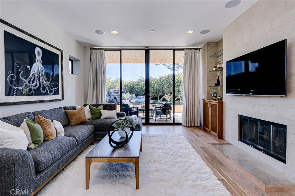 425 26th Street Manhattan Beach, CA 90266 - Photo 11 of 55 a living room with furniture a flat screen tv and a fireplace
