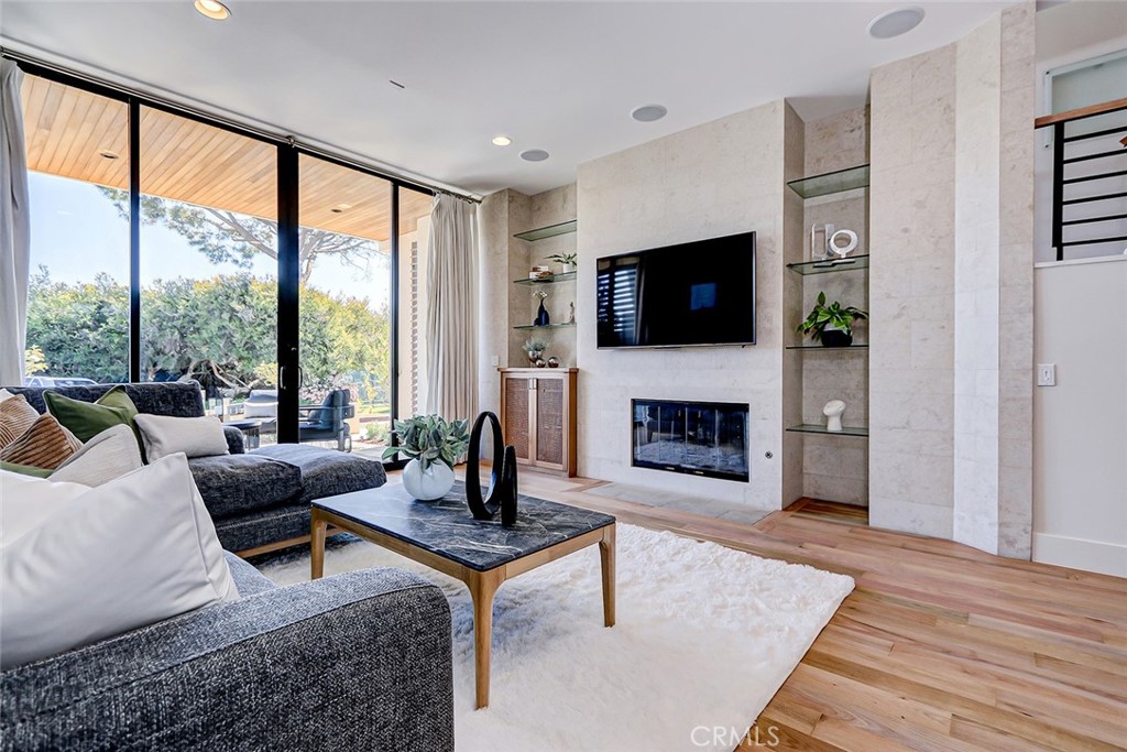 425 26th Street Manhattan Beach, CA 90266 - Photo 13 of 55 a living room with furniture a flat screen tv and a fireplace