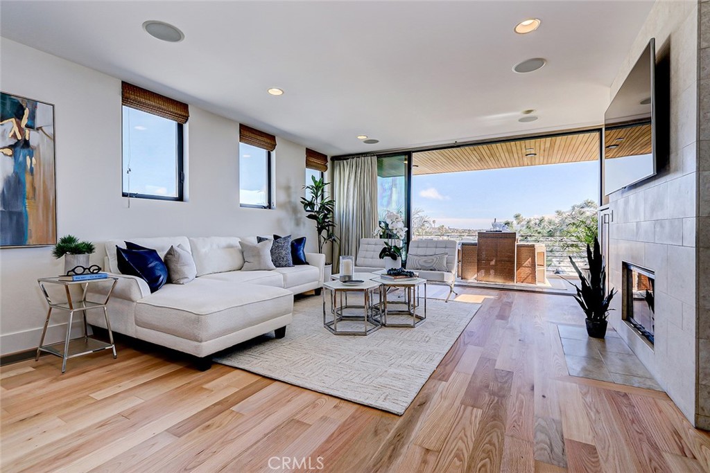 425 26th Street Manhattan Beach, CA 90266 - Photo 22 of 55 a living room with fireplace furniture and a wooden floor