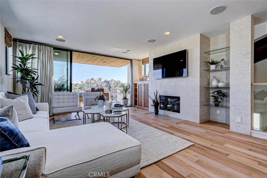 425 26th Street Manhattan Beach, CA 90266 - Photo 23 of 55 a living room with furniture a fireplace and a flat screen tv
