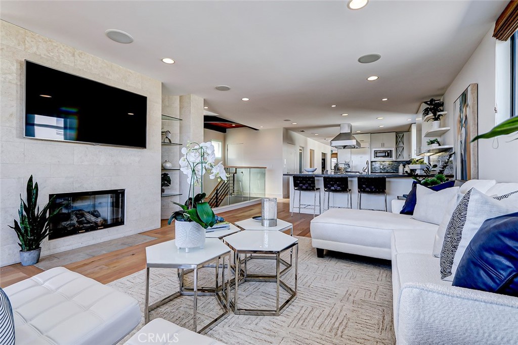425 26th Street Manhattan Beach, CA 90266 - Photo 25 of 55 a living room with furniture a flat screen tv and a fireplace