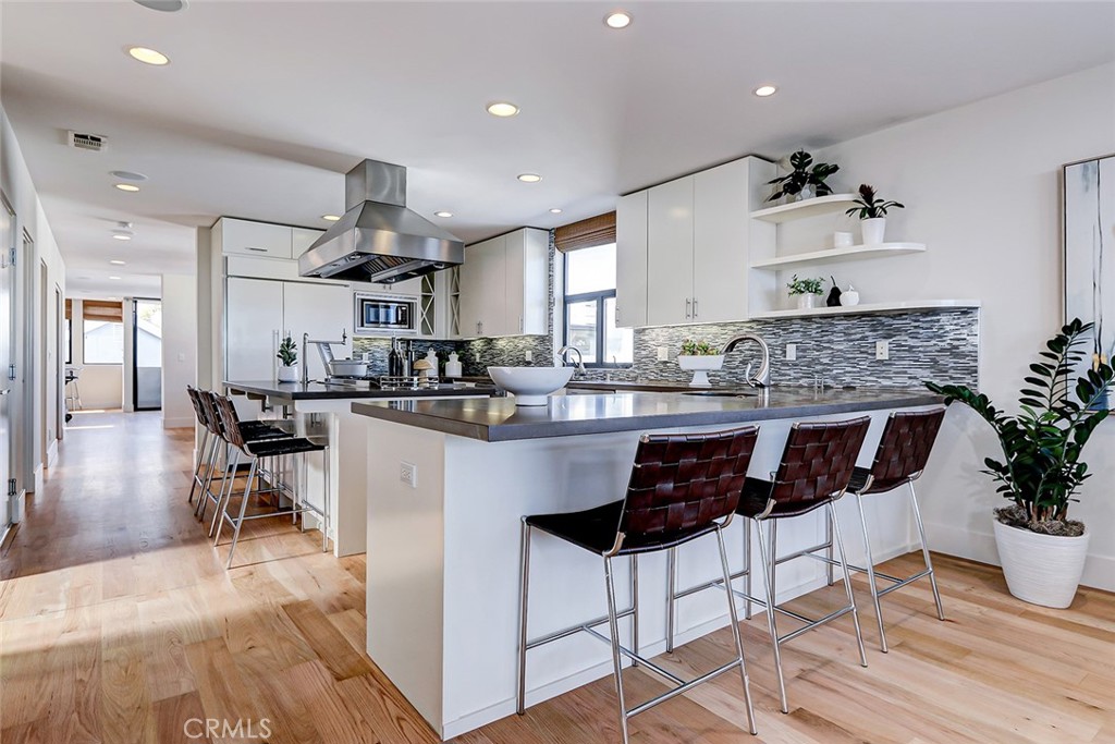 425 26th Street Manhattan Beach, CA 90266 - Photo 27 of 55 a kitchen with stainless steel appliances kitchen island granite countertop a sink and cabinets