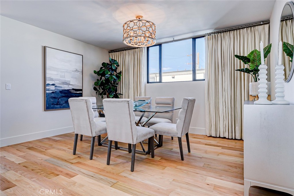425 26th Street Manhattan Beach, CA 90266 - Photo 33 of 55 a dining room with furniture potted plants and wooden floor