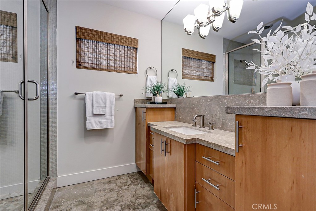 425 26th Street Manhattan Beach, CA 90266 - Photo 48 of 55 a bathroom with a granite countertop sink a large mirror and a shower