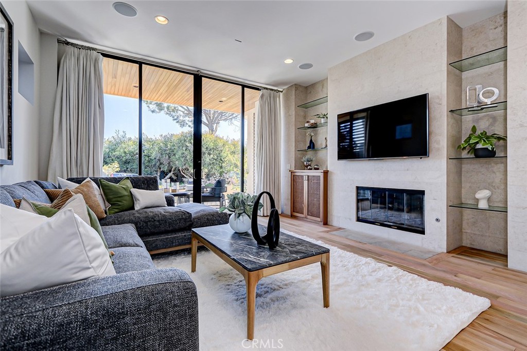 425 26th Street Manhattan Beach, CA 90266 - Photo 5 of 55 a living room with furniture a flat screen tv and a fireplace