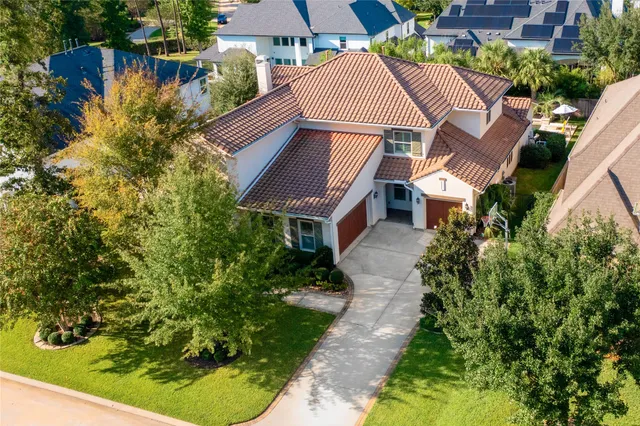 an aerial view of a house with a yard and potted plants