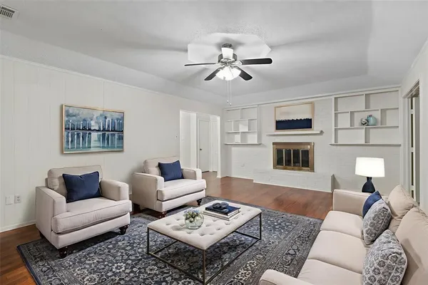 a living room with furniture ceiling fan and a rug