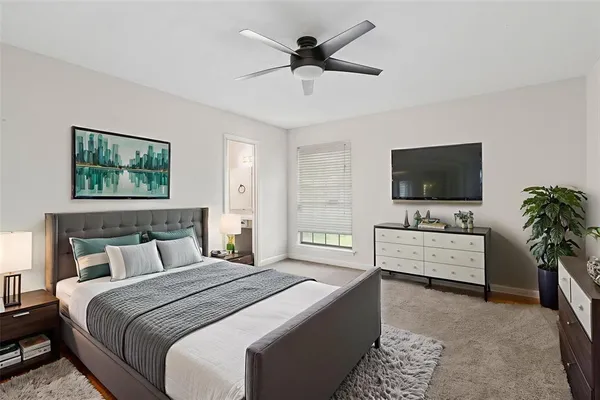 a bedroom with a bed and a flat screen tv