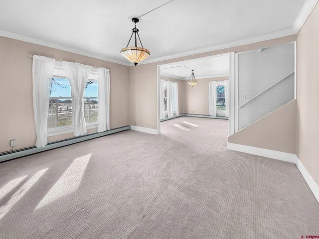 a view of a livingroom with an empty space and a window