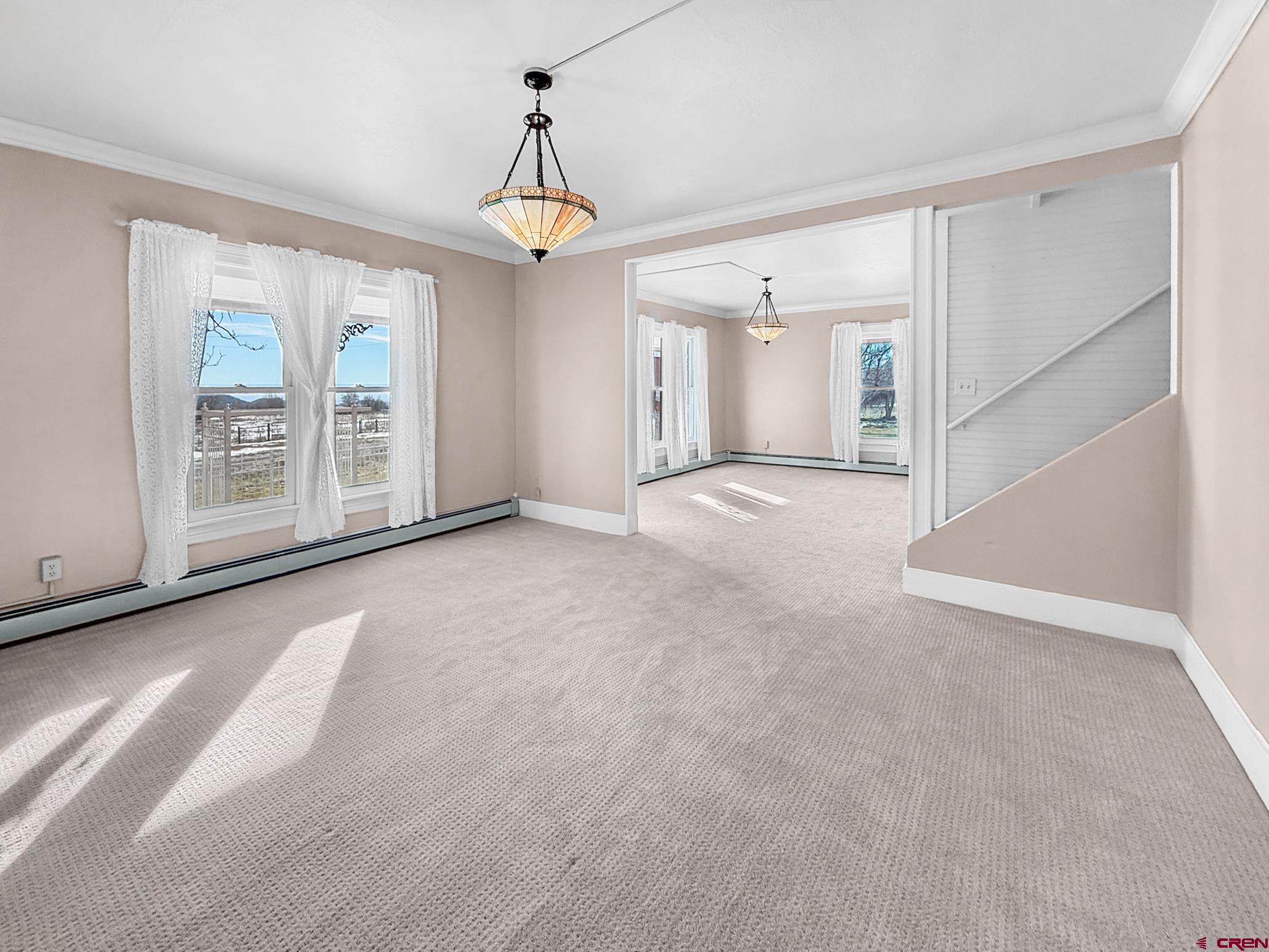 17343 Surface Creek Road Cedaredge, CO 81413 - Photo 12 of 45 a view of a livingroom with an empty space and a window