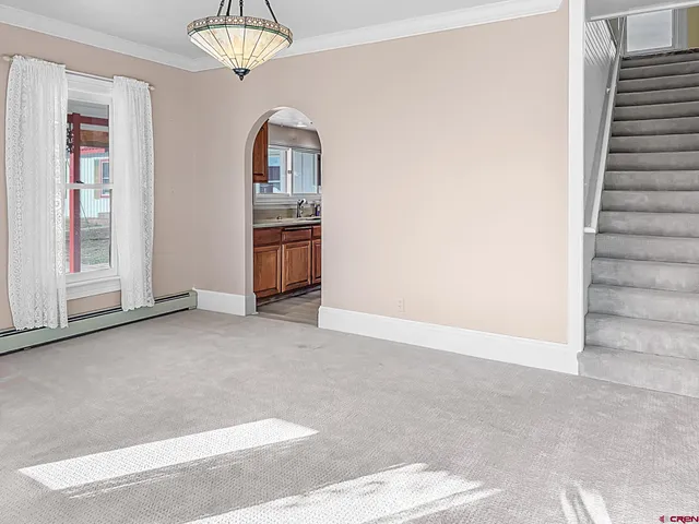a view of a bedroom with furniture and window