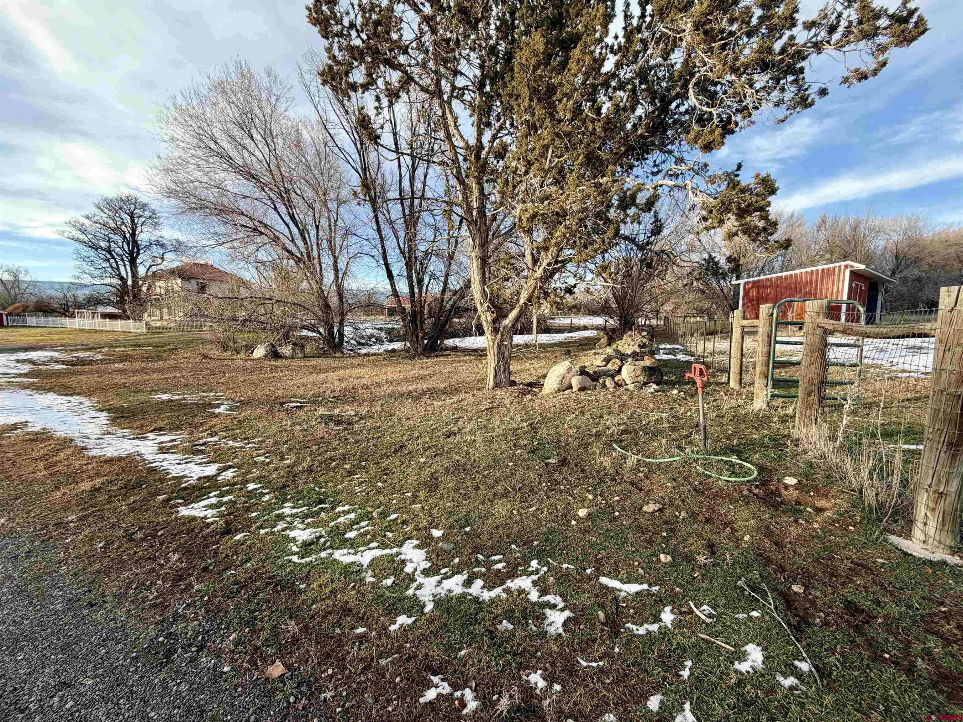 17343 Surface Creek Road Cedaredge, CO 81413 - Photo 32 of 45 a backyard of a house with lots of green space