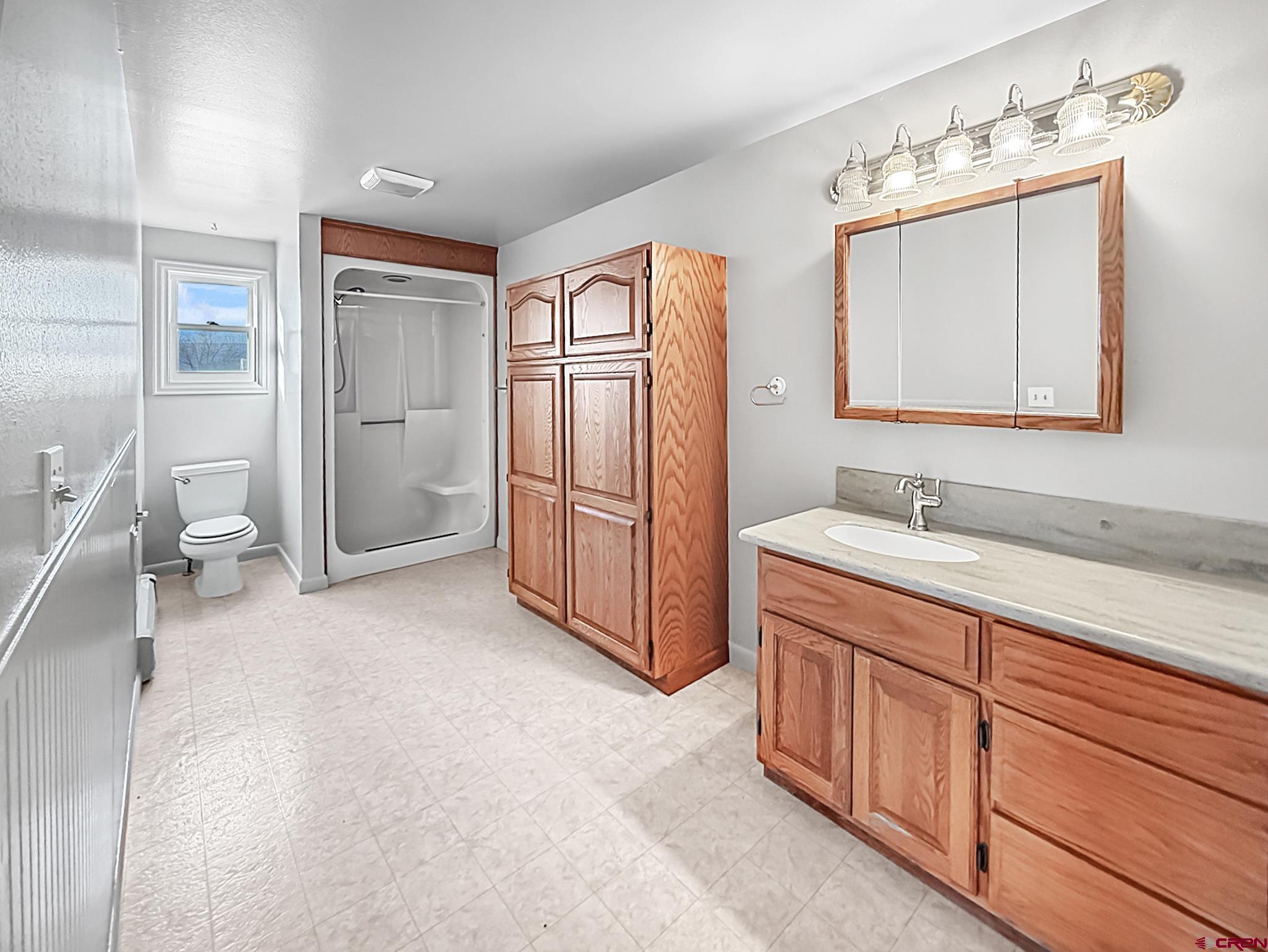 17343 Surface Creek Road Cedaredge, CO 81413 - Photo 10 of 45 a spacious bathroom with a double vanity sink and a mirror