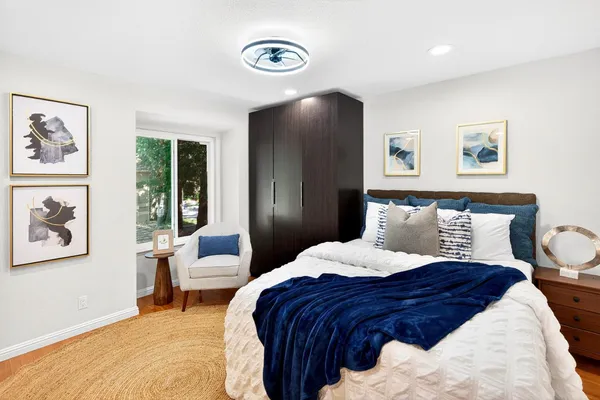 a bedroom with a large bed and a chandelier