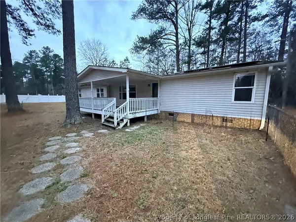 a backyard of a house with table and chairs
