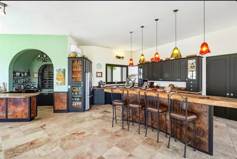 a bedroom with furniture and a large window