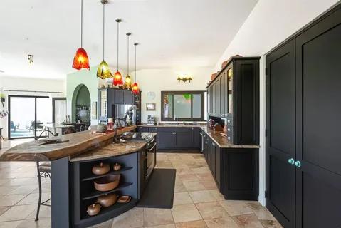 a bathroom with double vanity and a mirror
