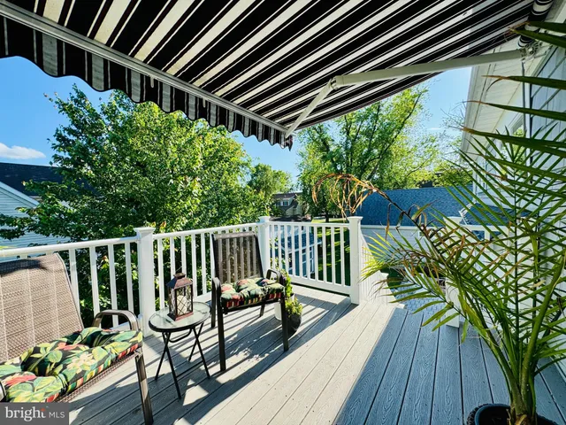 a view of balcony with wooden floor and outdoor seating
