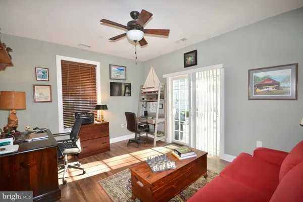 a living room with furniture a flat screen tv and a window