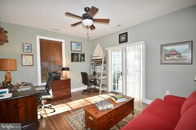 a living room with furniture a flat screen tv and a window