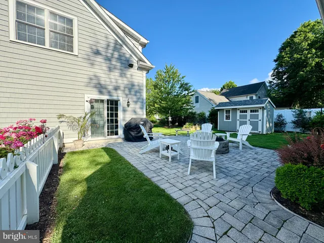 a view of a house with backyard sitting area and garden