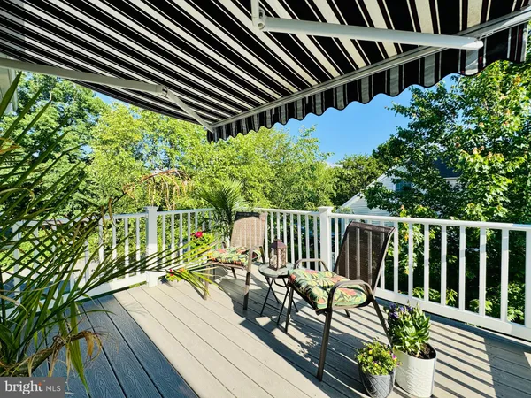 a view of balcony with wooden floor and fence