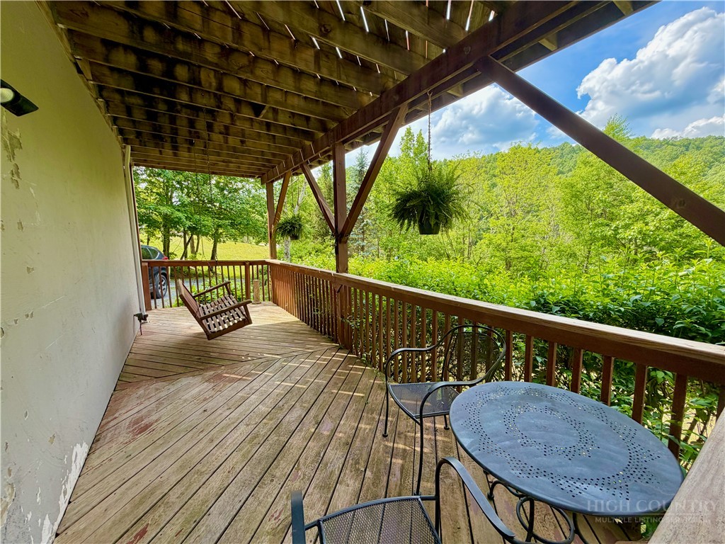 1173 Hopewell Church Road Boone, NC 28607 - Photo 31 of 39 a view of balcony with wooden floor and outdoor seating